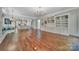 Open living room with hardwood floors, custom built-ins, and open kitchen with island at 128 Spears Creek Dr, Mooresville, NC 28117