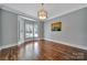 Spacious living room featuring hardwood floors, a decorative chandelier, and a bright bay window at 128 Spears Creek Dr, Mooresville, NC 28117