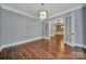 Bright living room showing hardwood floors, large windows, and open french doors at 128 Spears Creek Dr, Mooresville, NC 28117