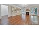 Cozy living room with hardwood floors, built-in bookshelves, and fireplace with French doors at 128 Spears Creek Dr, Mooresville, NC 28117