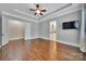 Spacious main bedroom boasts hardwood floors, and ensuite bathroom and walk-in closet entrances at 128 Spears Creek Dr, Mooresville, NC 28117