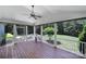 Inviting screened porch featuring wood flooring, ceiling fan, and views of the lush backyard at 128 Spears Creek Dr, Mooresville, NC 28117