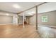 Large basement with light walls, hardwood floors, a staircase, and a window at 131 Little Forest Ln, Statesville, NC 28625
