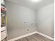 A utility room with grey paint, a hot water heater, and gray wood-look flooring at 131 Little Forest Ln, Statesville, NC 28625