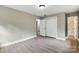 Bedroom with neutral walls, hardwood floors, closet, and access to bathroom at 131 Little Forest Ln, Statesville, NC 28625