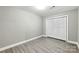 Clean bedroom with light grey wood floors, fresh paint, bright lighting, and a large closet space at 131 Little Forest Ln, Statesville, NC 28625