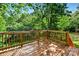 Wood deck surrounded by lush trees provides an outdoor living space with natural views at 131 Little Forest Ln, Statesville, NC 28625