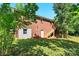 Back exterior view shows a brick two-story home with a wood deck and lush yard at 131 Little Forest Ln, Statesville, NC 28625