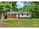 Charming single-story home with brick and siding, surrounded by mature trees at 131 Little Forest Ln, Statesville, NC 28625