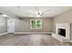 A bright living room featuring a decorative fireplace, neutral paint, updated flooring, and natural light at 131 Little Forest Ln, Statesville, NC 28625