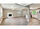 Expansive living area featuring a decorative fireplace, neutral paint, and seamless flow to a modern kitchen at 131 Little Forest Ln, Statesville, NC 28625