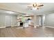 Open-concept space with combined living room and kitchen featuring white cabinets and modern appliances at 131 Little Forest Ln, Statesville, NC 28625