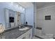 Bright bathroom with subway tiled shower, large mirror, and neutral color scheme at 1608 Sharon W Rd # 55, Charlotte, NC 28210