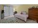 Comfortable bedroom featuring soft lighting, a plush rug, and a wooden dresser with decorative items at 1608 Sharon W Rd # 55, Charlotte, NC 28210