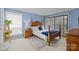 Cozy bedroom with a four-poster bed, neutral carpet, and sliding glass door at 1608 Sharon W Rd # 55, Charlotte, NC 28210
