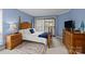 Cozy bedroom with a four-poster bed, neutral carpet, and sliding glass door at 1608 Sharon W Rd # 55, Charlotte, NC 28210