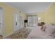 Cozy bedroom with access to a balcony, mirrored closet doors, and a soft, patterned rug at 1608 Sharon W Rd # 55, Charlotte, NC 28210
