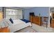 Light and airy bedroom with wooden furniture, neutral carpet, and large window at 1608 Sharon W Rd # 55, Charlotte, NC 28210