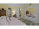 Inviting bedroom with yellow walls, neutral carpet, and a mirrored closet door reflecting the bedroom at 1608 Sharon W Rd # 55, Charlotte, NC 28210