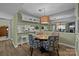 Cozy dining area adjacent to kitchen with stylish chairs and unique lighting fixtures at 1608 Sharon W Rd # 55, Charlotte, NC 28210