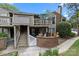 Attractive two-story condo with a cozy patio, upper deck, brick accents, and lush landscaping at 1608 Sharon W Rd # 55, Charlotte, NC 28210
