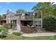 Charming townhouse with brick accents, a second-floor balcony, and manicured landscaping at 1608 Sharon W Rd # 55, Charlotte, NC 28210