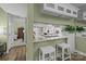 View of a modern kitchen from the bar area, showcasing granite countertops and stainless appliances at 1608 Sharon W Rd # 55, Charlotte, NC 28210