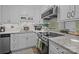 Updated kitchen featuring granite countertops, modern stainless steel appliances, and sleek white cabinetry at 1608 Sharon W Rd # 55, Charlotte, NC 28210