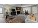 Cozy living room showcasing a brick fireplace, comfortable seating, and natural light from the window at 1608 Sharon W Rd # 55, Charlotte, NC 28210