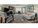 Comfortable living room with fireplace, neutral sofa, area rug, and lots of light from large windows at 1608 Sharon W Rd # 55, Charlotte, NC 28210