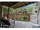 Inviting patio with brick fencing, lush garden, and comfortable seating area for outdoor enjoyment at 1608 Sharon W Rd # 55, Charlotte, NC 28210