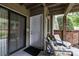 Inviting covered patio featuring comfortable seating, a view of greenery, and a sliding glass door entrance at 1608 Sharon W Rd # 55, Charlotte, NC 28210