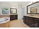 Elegant bathroom with granite countertops, soaking tub, and tiled floor at 1614 Tarrington Way, Indian Trail, NC 28079