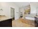 Bright bathroom features granite countertops, soaking tub, and walk-in closet at 1614 Tarrington Way, Indian Trail, NC 28079