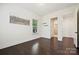 Bright bedroom features hardwood floors, neutral walls, and a window at 1614 Tarrington Way, Indian Trail, NC 28079