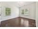 Bedroom with dark wood floors, and two large windows at 1614 Tarrington Way, Indian Trail, NC 28079
