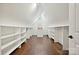 Walk-in closet featuring custom shelving, wood floors, and natural light at 1614 Tarrington Way, Indian Trail, NC 28079