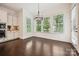 Cozy dining area with hardwood floors, large windows, and modern chandelier near the kitchen at 1614 Tarrington Way, Indian Trail, NC 28079