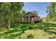 The exterior of this home features a brick facade and a backyard with a playset and fire pit at 1614 Tarrington Way, Indian Trail, NC 28079