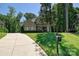 Beautiful home exterior with manicured lawn, mature trees, and a long driveway at 1614 Tarrington Way, Indian Trail, NC 28079