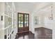 Spacious foyer with hardwood floors, white trim, and a view of the yard through glass paneled double doors at 1614 Tarrington Way, Indian Trail, NC 28079