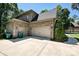 Attached two car garage with carriage doors, and ample parking space in a brick home at 1614 Tarrington Way, Indian Trail, NC 28079