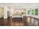 Bright kitchen with white cabinets, granite countertops, stainless appliances, and hardwood floors at 1614 Tarrington Way, Indian Trail, NC 28079