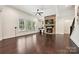 Living room with stone fireplace, hardwood floors, and large windows offering natural light at 1614 Tarrington Way, Indian Trail, NC 28079
