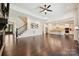Bright living room with stairs, hardwood floors, and an open kitchen at 1614 Tarrington Way, Indian Trail, NC 28079