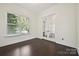 Office with hardwood floors, a large window, white trim and glass French doors to separate the space at 1614 Tarrington Way, Indian Trail, NC 28079
