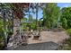 Expansive brick patio with outdoor kitchen, dining and fireplace seating area with lush landscaping at 17924 River Ford Dr, Davidson, NC 28036