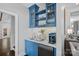 Charming bar area features custom cabinets, marble countertop, and beverage center at 17924 River Ford Dr, Davidson, NC 28036