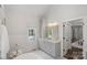 An elegant white bathroom is illuminated by stylish gold fixtures at 17924 River Ford Dr, Davidson, NC 28036