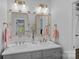 Bright bathroom featuring double vanity, marble countertop, gold fixtures, and stylish decor at 17924 River Ford Dr, Davidson, NC 28036